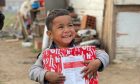 a small boy, Ismedin is all smiles as he receives a gift from Blythswood's Christmas shoebox appeal in the UK