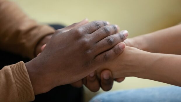 hands of two people clasped together