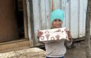 boy in Kosovo receives a shoebox from Blythswood Care's shoebox appeal