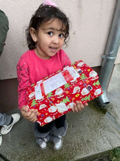 little girl receives a shoebox from Blythswood Care's shoebox appeal