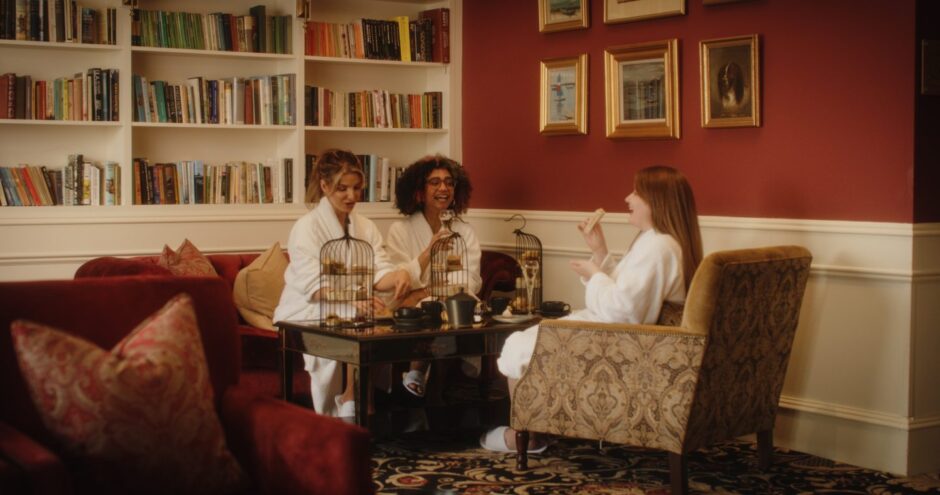 three women in bathrobes enjoy tea at a suite in Golf View Hotel