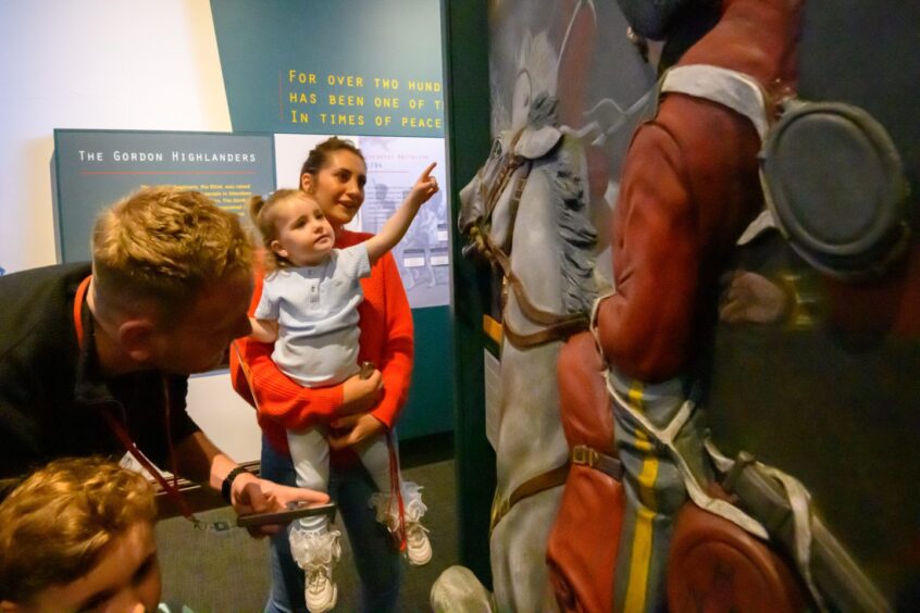 family checks out an exhibit at Gordon Highlanders Museum in Aberdeen