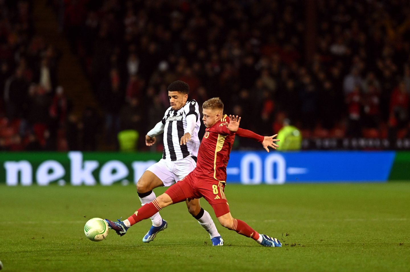 Aberdeen's Connor Barron and PAOK's Taison battle for the ball. 