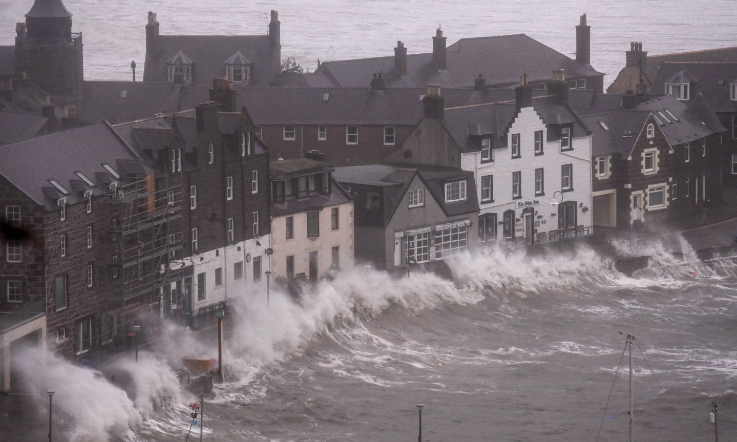 Waves blown up against the buildings on the seafront in Stonehaven. 