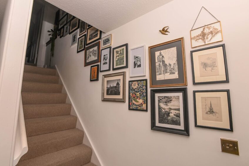 The photo gallery wall next to the staircase