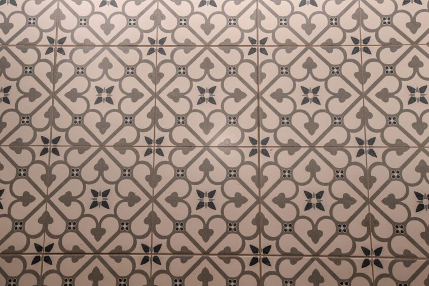 The grey patterned floor tiles in the hallway