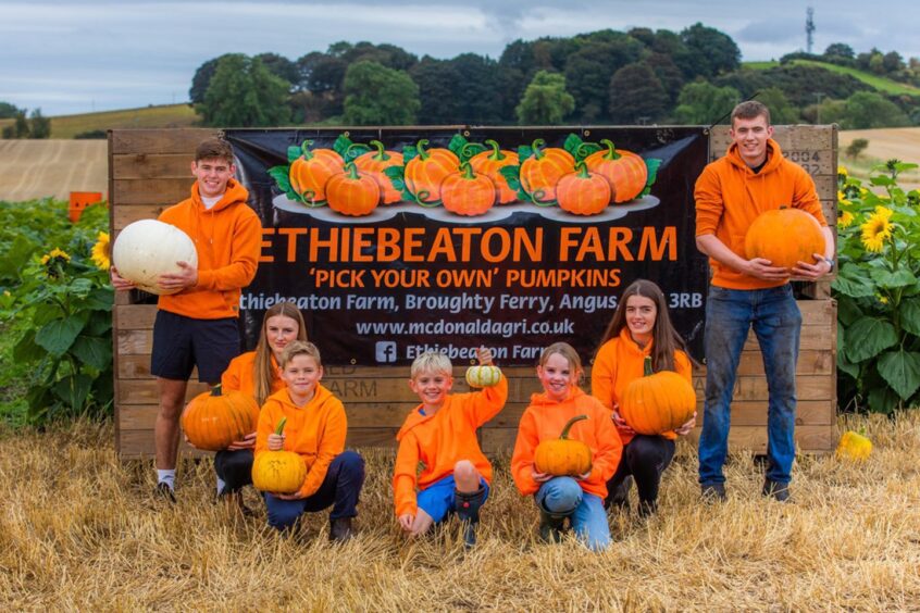 Family posing in front of Ethiebeaton Farm offering family-friendly Halloween activities in Aberdeenshire and Dundee.