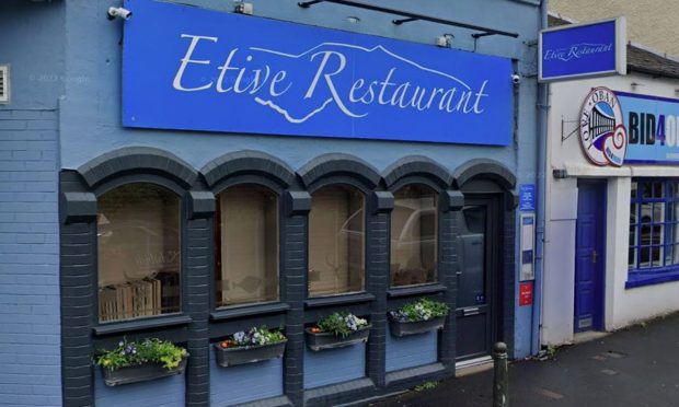 The facade of Etive Restaurant in Oban with its blue sign and black framed windows.