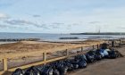 Rubbish bags lined up at Aberdeen beach.
