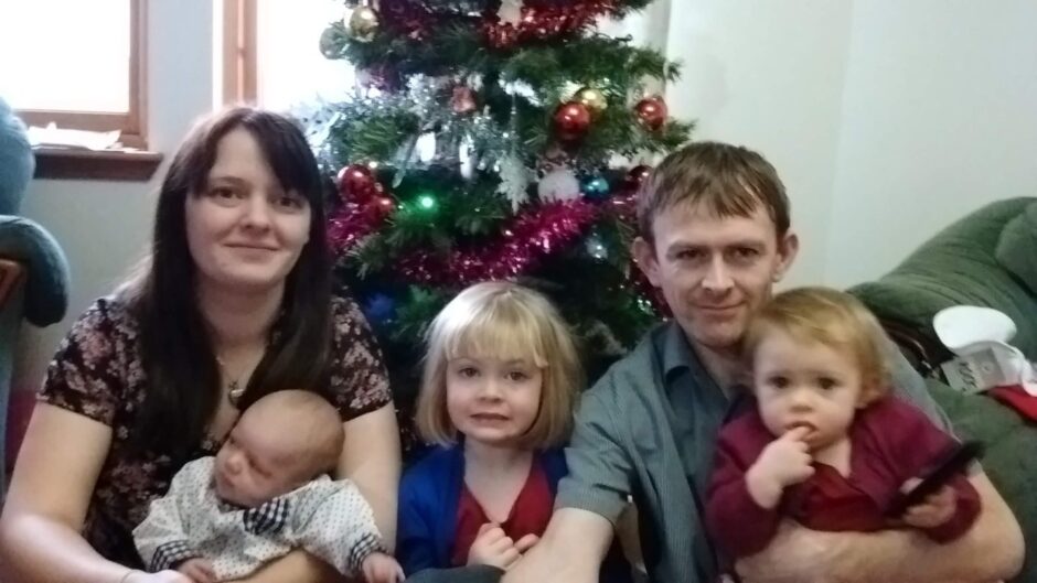 Ullapool mum, Nina, and Joseph Hilton with their children Lachie, Marina and Emma, a Christmas tree behind them