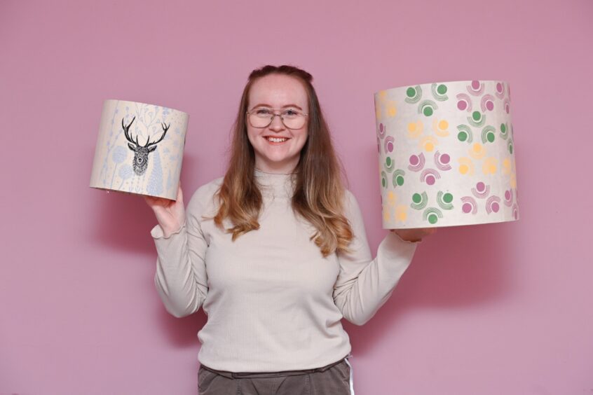 Holly Lazenby holding two lanpshades