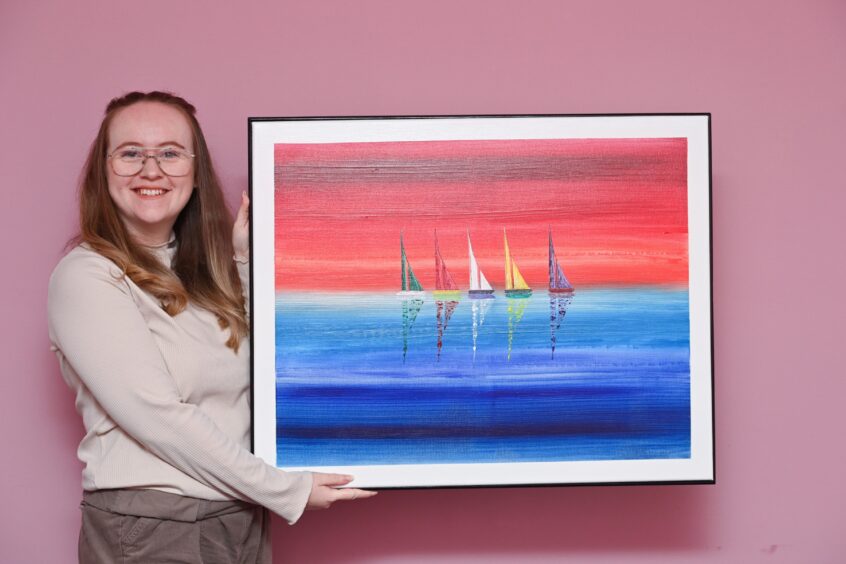 Holly Lazenby with a painting of five sailboats 