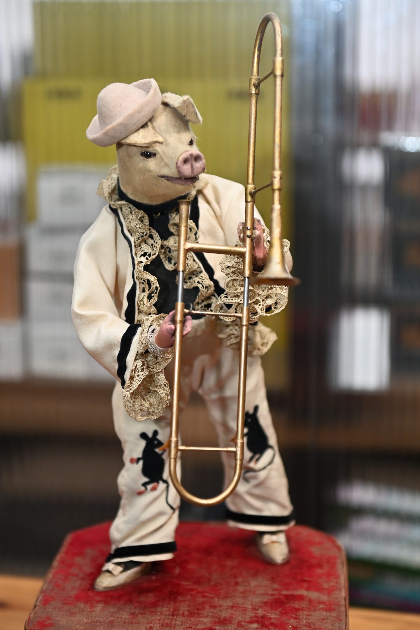 Pig automata holding trombone.