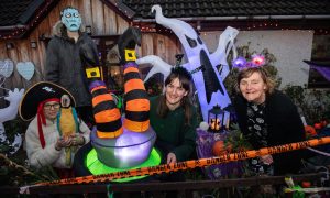 The Stewart family surrounded by Halloween decorations in front garden.