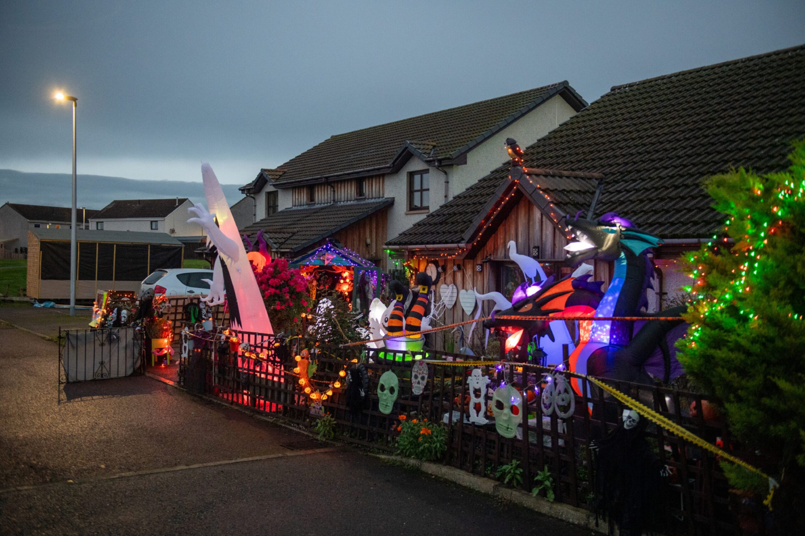 View of Halloween lights in front garden with other properties in background. 