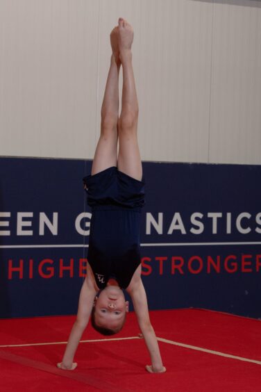 Archie does a handstand at the Aberdeen Gymnastics Centre.