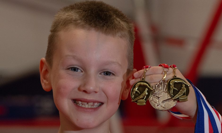 Aberdeen gymnast Archie with a selection of the medals he's won so far.