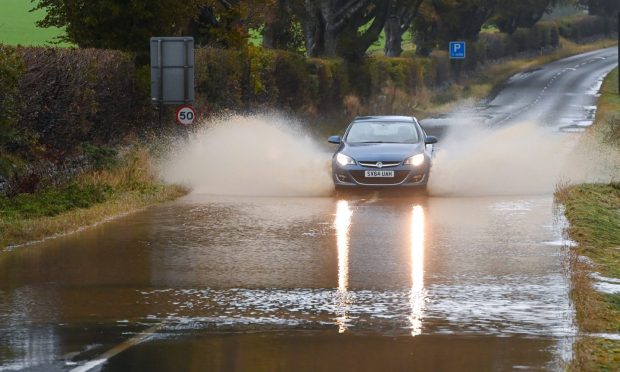 Car driving through flooding in Westhill