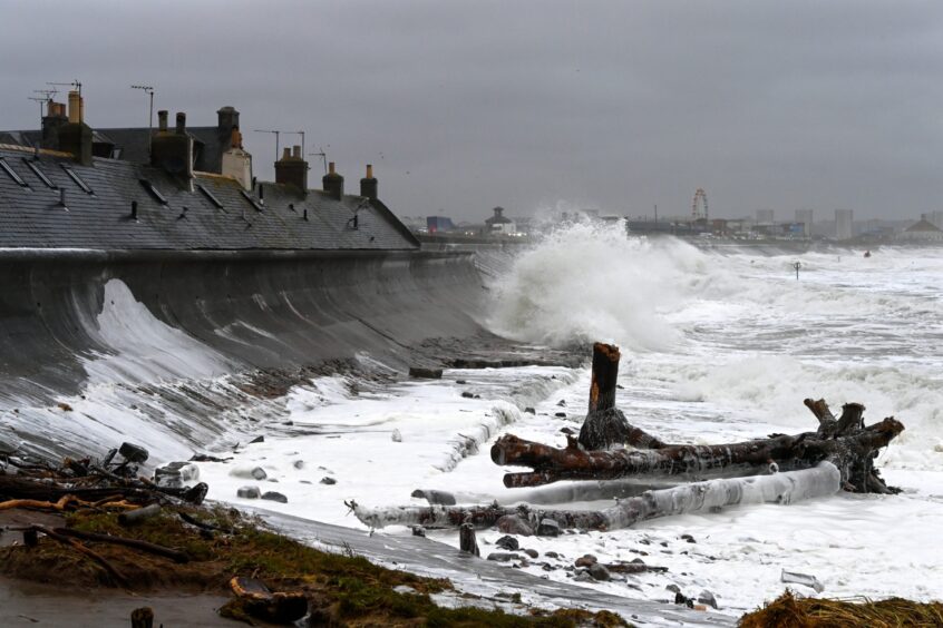Waves batter against Footdee seafront.