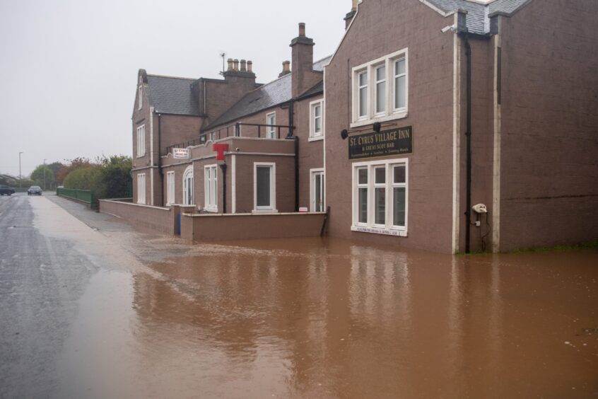 St Cyrus Village Inn surrounded by flood water.