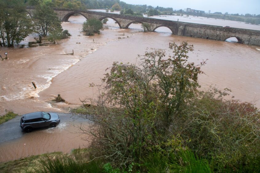 Car tries to move through the flooding near Northwater Bridge, Aberdeenshire. 