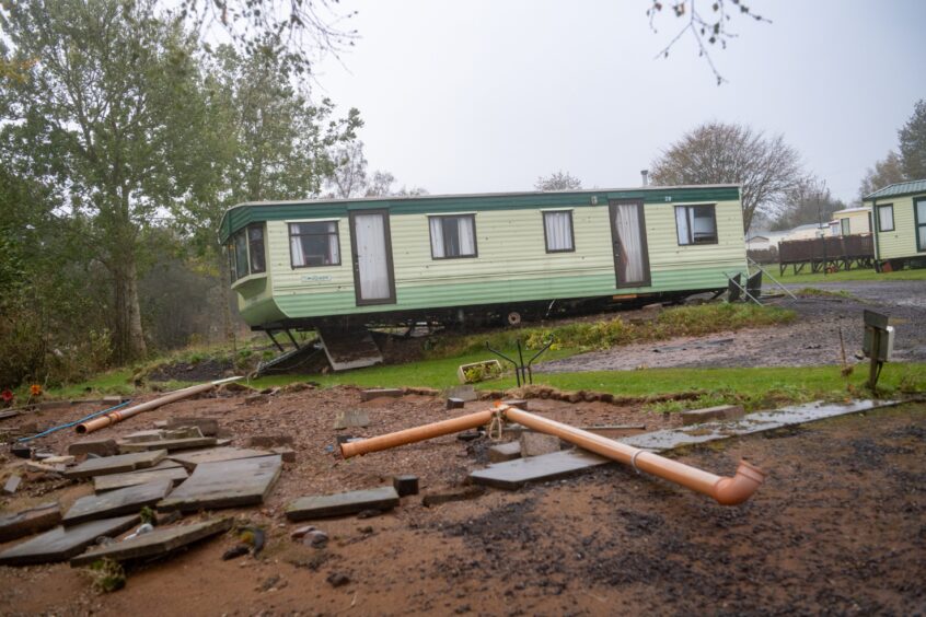 Strewn pipework and bricks show damaged caused at Dovecot Caravan Park by Storm Babet.