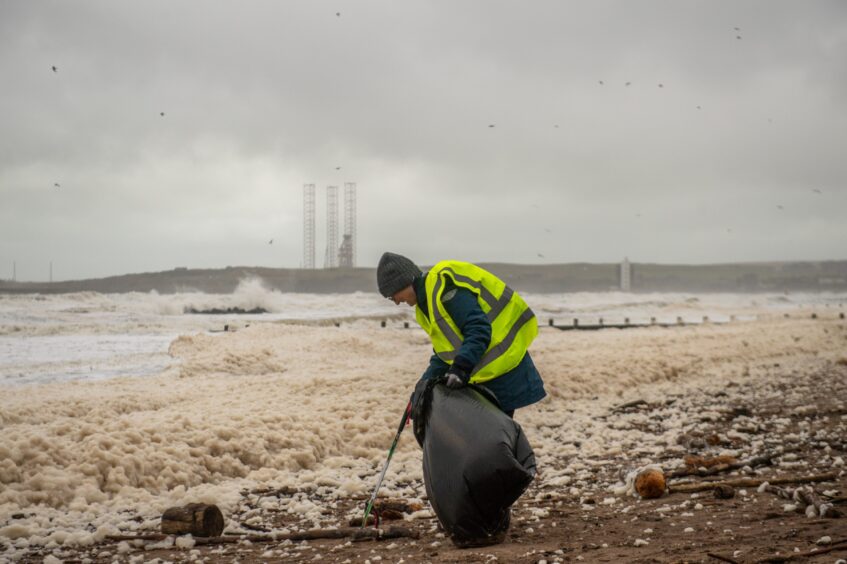 Volunteer picking up litter.