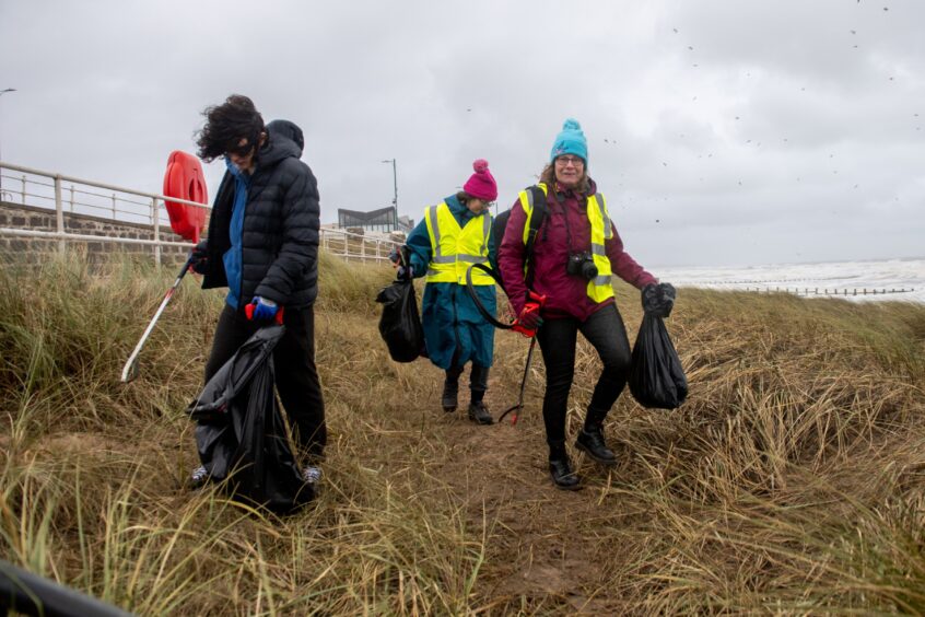 Volunteers picking up litter.