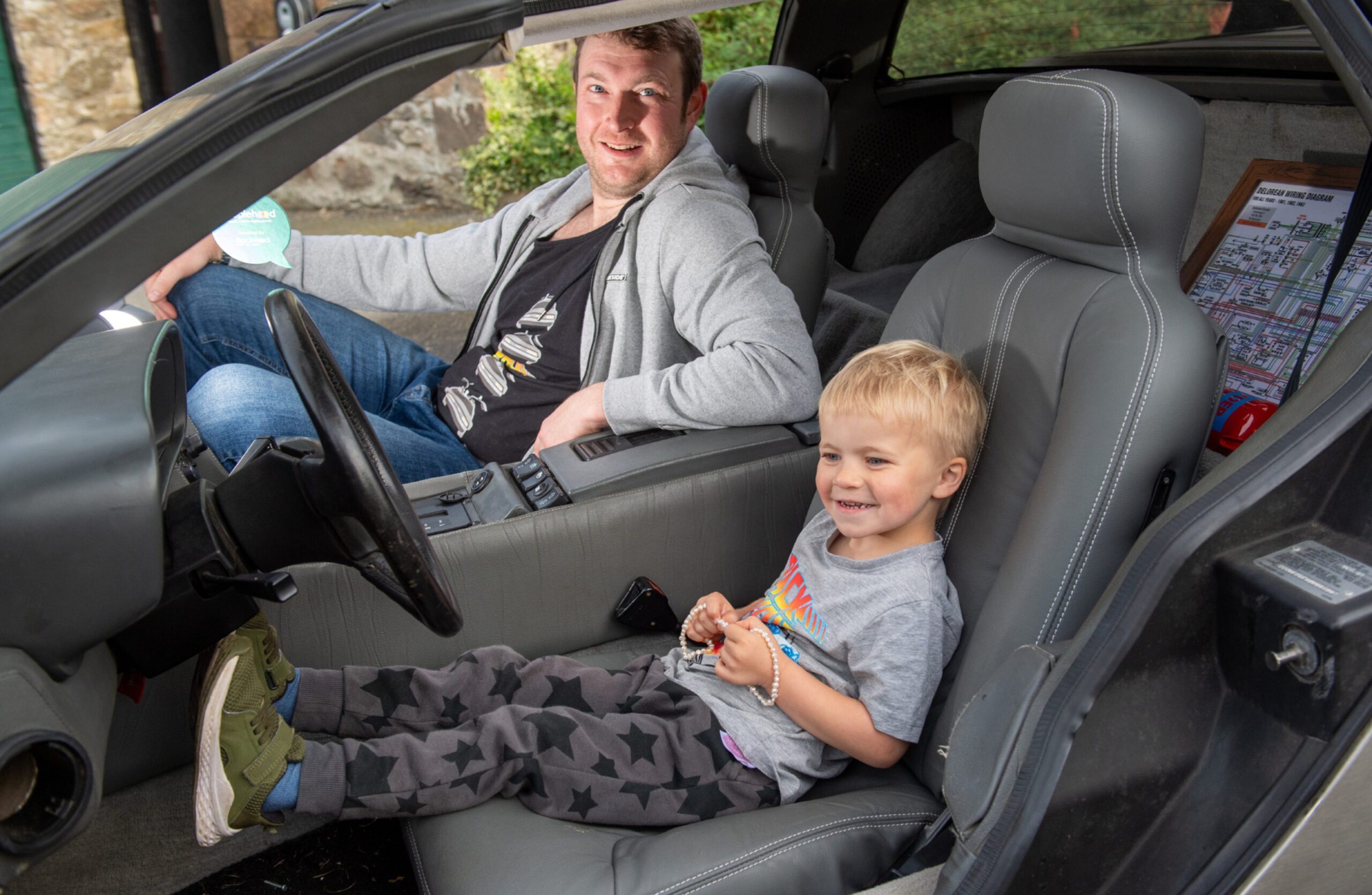 Fraser, 4, nearest camera in driver's seat of DeLorean with dad John behind. 
