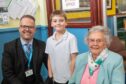 Head Teacher Ross Watson with pupil Flynn Mulloy P6 and 93 year old former pupil Millicent Birse. 
Image: Kami Thomson/DC Thomson