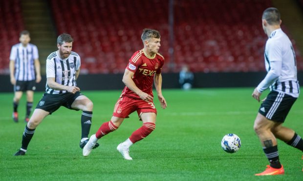 Adam Emslie of Aberdeen with Fraserburgh's Lewis Davidson in pursuit during a 2023 Aberdeenshire Cup tie. Image: Kami Thomson/DC Thomson.