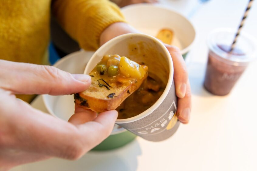 Andy dipping the M&S cafe ciabatta in the chicken pot pie soup.