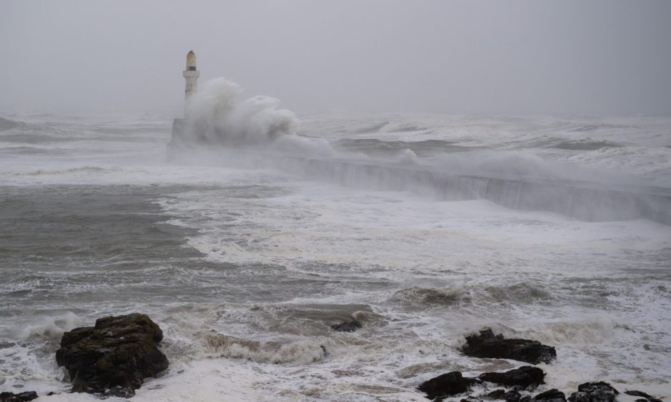 Waves crashing at Aberdeen lighthouse during Storm Babet.