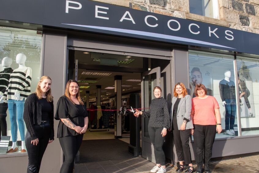 Assistant manager Emma McCann cutting the ribbon to open the new Peacocks store