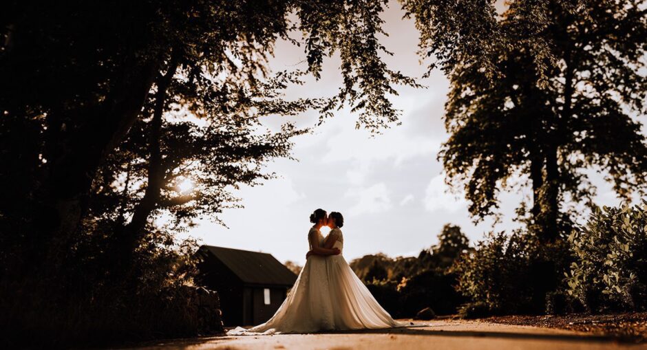 Two brides photographed on their wedding day by the Cove photographer.