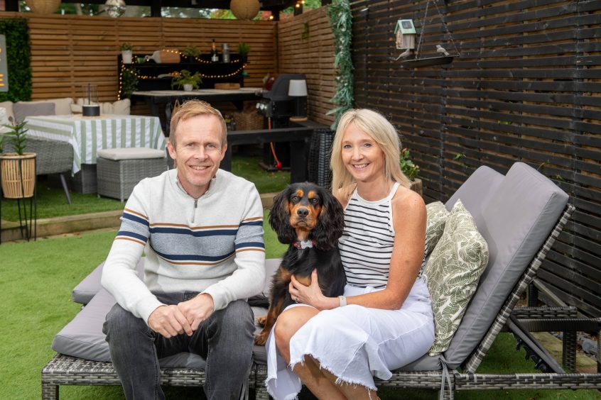 Allan and Lesley Taylor with their dog in the garden of their Bridge of Don home.