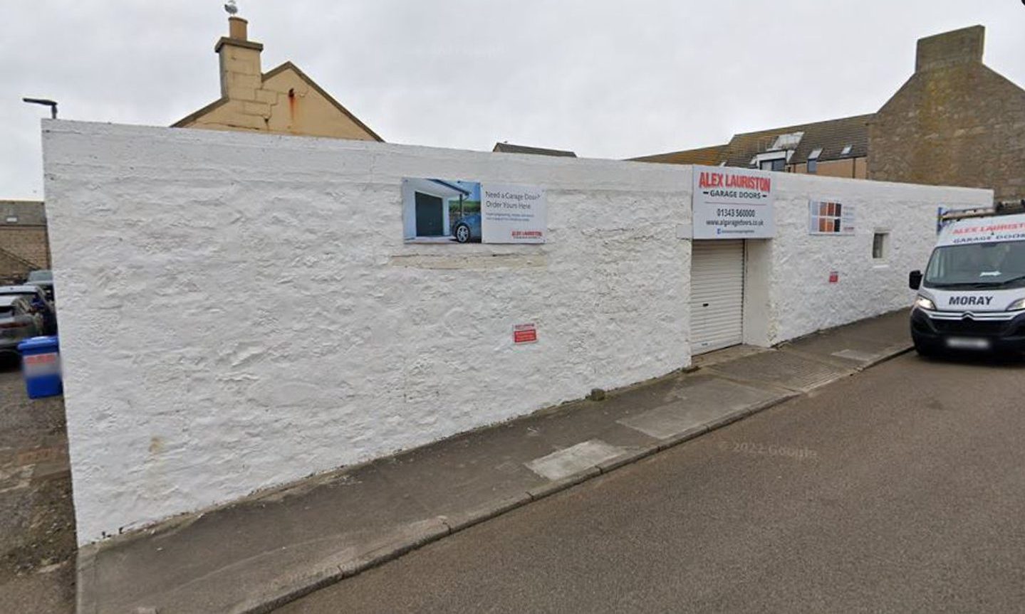 Google Maps image of single-storey white brick building. 