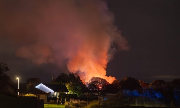 Flames rising above houses in Lossiemouth