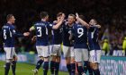 Scotland players celebrate during a Euro 2024 qualifying match against Spain at Hampden.