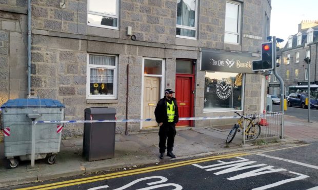 Police at a cordon on Menzies Road.