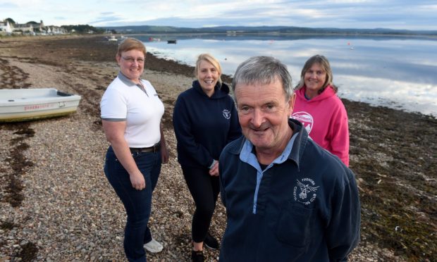 Maclean Macleod of Findhorn with three fellow members of the Findhorn Coastal Rowing Club who saved his life after a cardiac arrest on the boat.