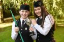 Ciorstaidh MacLean of Lionacleit School (left) winner of the Roderick Ross, Ferintosh Memorial Trophy for chanter in the novice category. Also in the photograph lending her congratulations is sister, Caitaidh who was competing in other competitions. Image: Sandy McCook/DC Thomson 