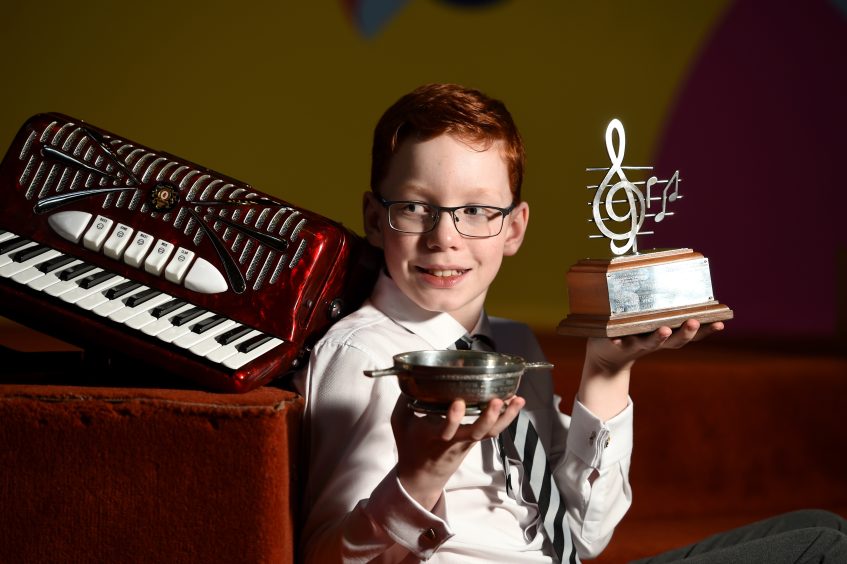 Alistair Adamson of Forth Primary School with his trophies for accordion playing.