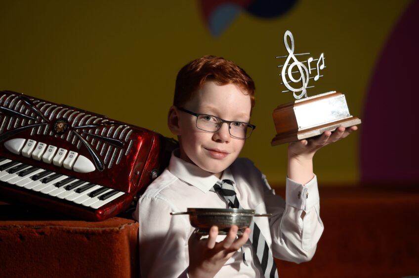 Alistair Adamson of Forth Primary School with his trophies for accordion playing, received on the first day of the Royal National Mod.