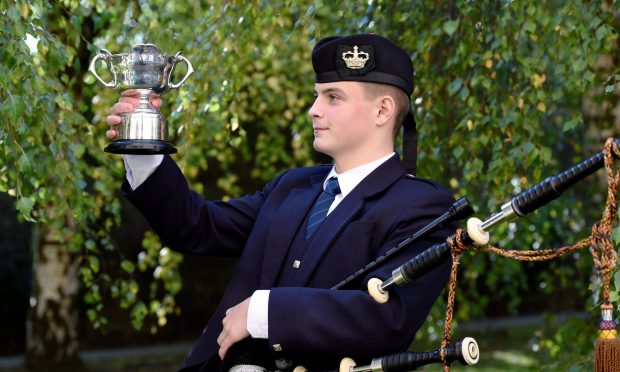 Arran Green of Bannpockburn High School with the Royal Highland Fusiliers Cup for 2/4 March, Strathspey and Reel in the 16-18 age category.