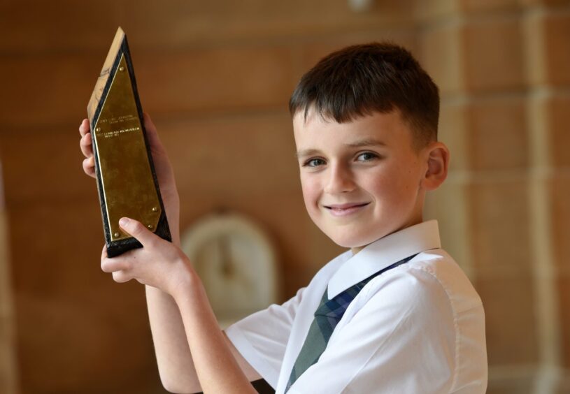 Finlay MacMillan of Inverness with the Tom and Rae Mitchell trophy for under 13 Traditional boys singing. This is the second year the trophy has been won by Finlay.