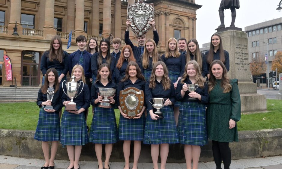 Sir E Scott School choir, with their conductress Jane Macdonald, of Tarbert, Harris with their haul of trophies from this mornings choral competitions .