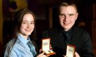 Winner of the An Commun Gaidhealach silver pendant, Isla Duke of the Falkirk and Alasdair Iain MacAoidh from Ardnamurchan, winner of the An Commun Gaidhealach Kilt Pin.