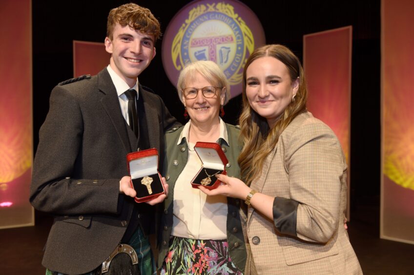 Winners of the Mod Gold Medals Iain MacCarmaig of Portree and Marina Nicleoid of Scalpay, Harris pictured with president of An Comunn Gaidhealach, Maggie Cunningham.