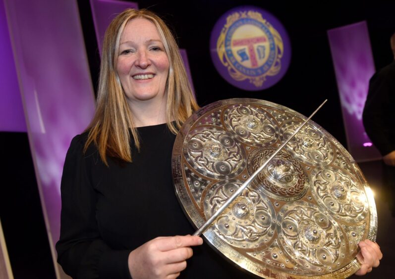Conductress Sileas Sinclair of the Oban Gaelic Choir pictured with the Lovat and Tullibardine Shield. 